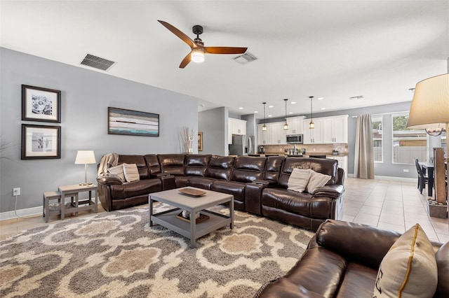 1436 30th Ave N, Saint Petersburg, FL 33704 - living room with light tile patterned floors, a ceiling fan, and baseboards