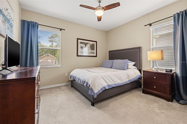 1436 30th Ave N, Saint Petersburg, FL 33704 - bedroom with multiple windows, light colored carpet, ceiling fan, and baseboards