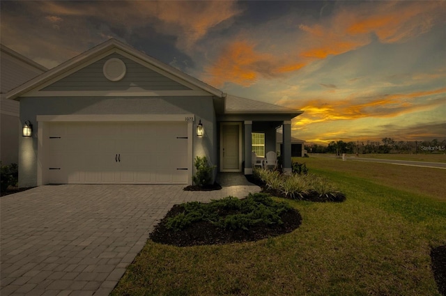 10153 Spruce River Way, Parrish, FL 34219 - ranch-style house with a front yard, decorative driveway, an attached garage, and stucco siding