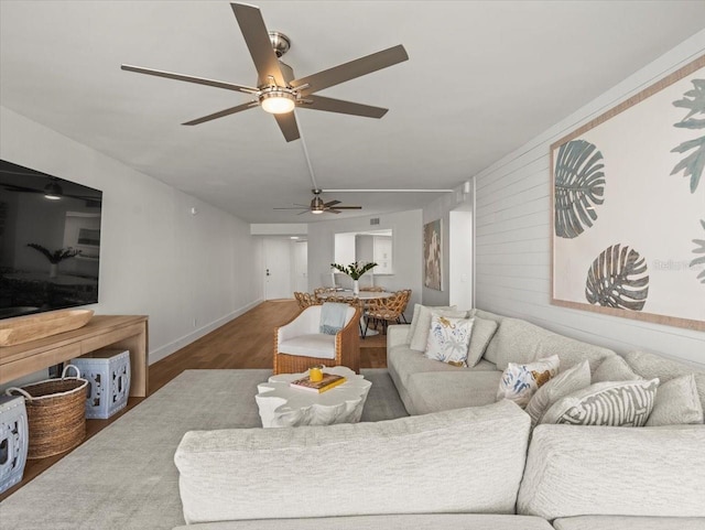 5700 Escondida Blvd S Unit 401, Saint Petersburg, FL 33715 - living area with a ceiling fan, wood finished floors, and baseboards