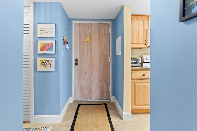 4900 Brittany Dr S Unit 209, Saint Petersburg, FL 33715 - doorway to outside with baseboards and light tile patterned floors
