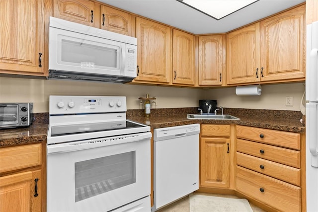 4900 Brittany Dr S Unit 209, Saint Petersburg, FL 33715 - kitchen featuring white appliances, a sink, and dark countertops