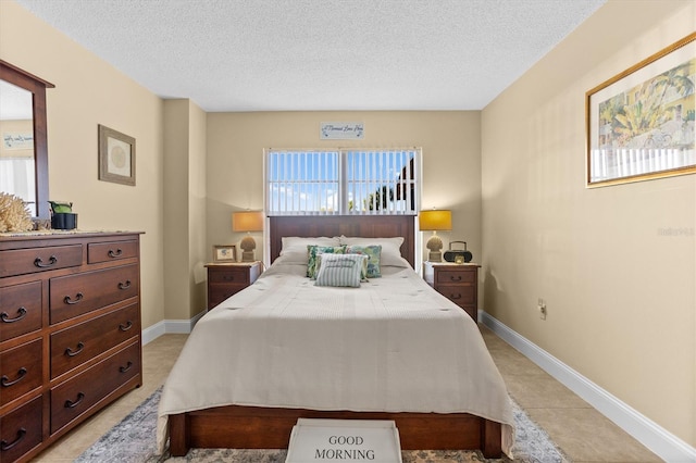 4900 Brittany Dr S Unit 209, Saint Petersburg, FL 33715 - bedroom featuring a textured ceiling, baseboards, and light tile patterned flooring