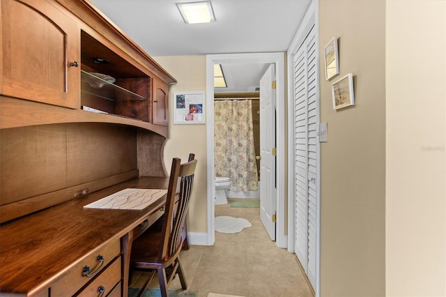 4900 Brittany Dr S Unit 209, Saint Petersburg, FL 33715 - home office with light tile patterned flooring and baseboards