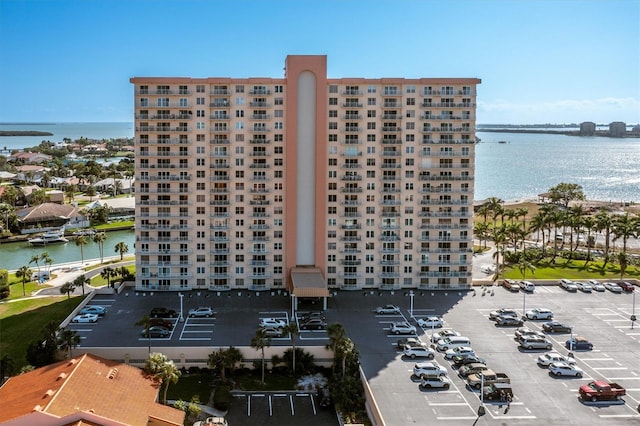 4900 Brittany Dr S Unit 209, Saint Petersburg, FL 33715 - view of apartment building / complex featuring a water view and uncovered parking