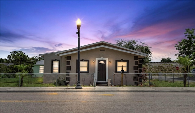 1101 Dr Martin L King Jr Way, Haines City, FL 33844 - bungalow-style home with stucco siding and a fenced front yard