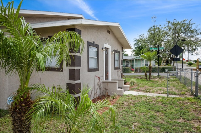 1101 Dr Martin L King Jr Way, Haines City, FL 33844 - view of home's exterior featuring stucco siding and fence