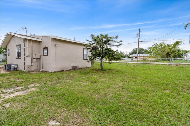1101 Dr Martin L King Jr Way, Haines City, FL 33844 - view of home's exterior featuring stucco siding and a lawn