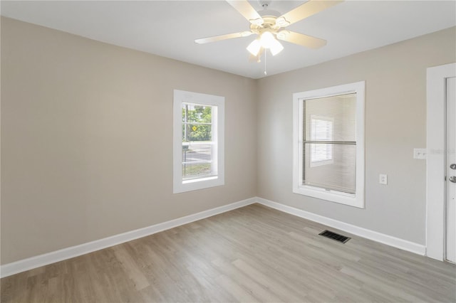 1101 Dr Martin L King Jr Way, Haines City, FL 33844 - unfurnished room with light wood finished floors, baseboards, and a ceiling fan