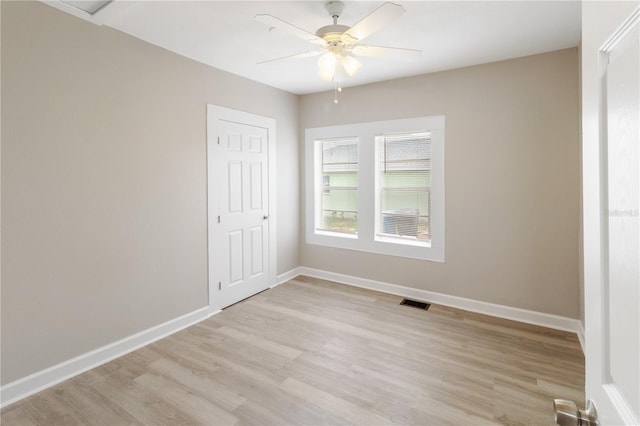 1101 Dr Martin L King Jr Way, Haines City, FL 33844 - unfurnished bedroom with light wood finished floors, baseboards, and ceiling fan