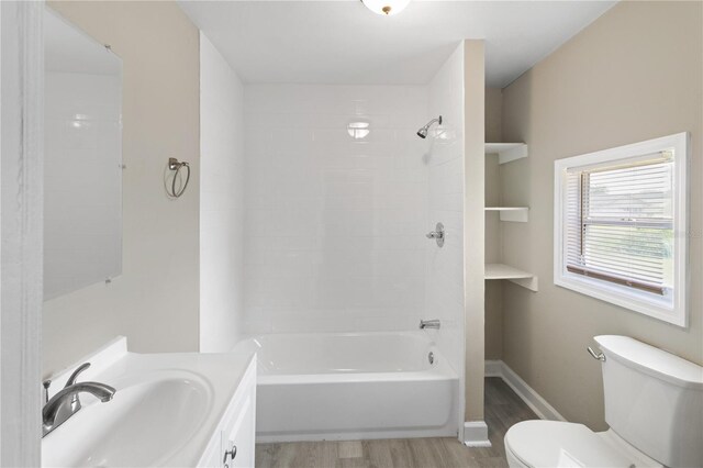 1101 Dr Martin L King Jr Way, Haines City, FL 33844 - bathroom featuring wood finished floors, toilet, vanity, and shower / tub combination