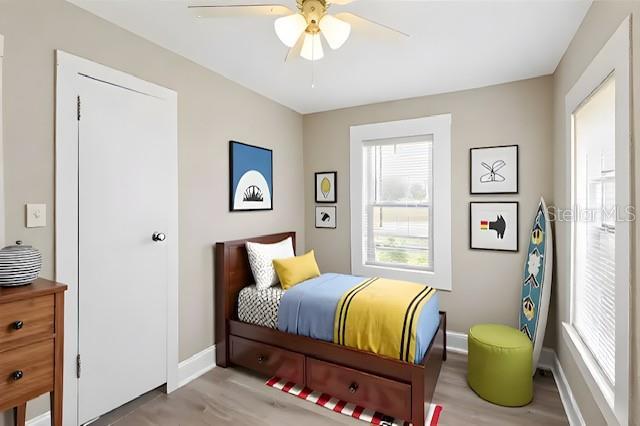 1101 Dr Martin L King Jr Way, Haines City, FL 33844 - bedroom featuring baseboards, wood finished floors, and ceiling fan