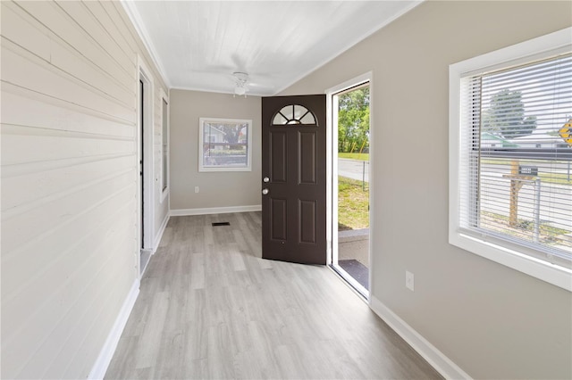 1101 Dr Martin L King Jr Way, Haines City, FL 33844 - foyer entrance featuring light wood finished floors, baseboards, and crown molding