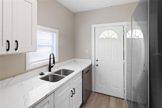 1101 Dr Martin L King Jr Way, Haines City, FL 33844 - kitchen with a sink, stainless steel dishwasher, plenty of natural light, and light wood-type flooring