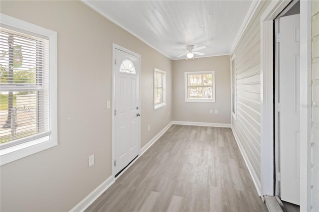 1101 Dr Martin L King Jr Way, Haines City, FL 33844 - foyer featuring ornamental molding, light wood-style floors, ceiling fan, and baseboards