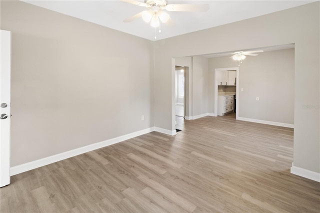 1101 Dr Martin L King Jr Way, Haines City, FL 33844 - empty room with a ceiling fan, light wood-style flooring, and baseboards