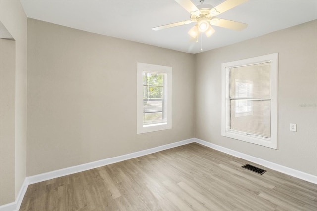 1101 Dr Martin L King Jr Way, Haines City, FL 33844 - unfurnished room with wood finished floors, baseboards, and a ceiling fan