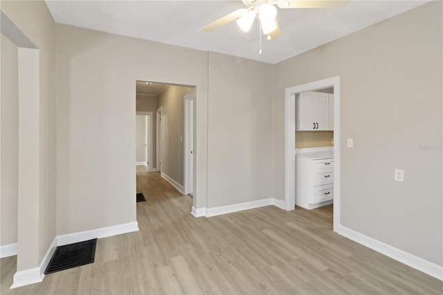 1101 Dr Martin L King Jr Way, Haines City, FL 33844 - unfurnished room featuring a ceiling fan, light wood-style floors, and baseboards