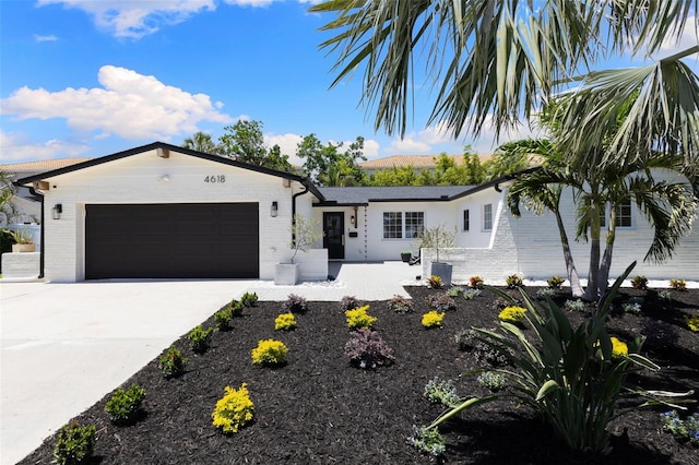 4618 Bayshore Blvd NE, Saint Petersburg, FL 33703 - single story home featuring a garage, concrete driveway, and brick siding
