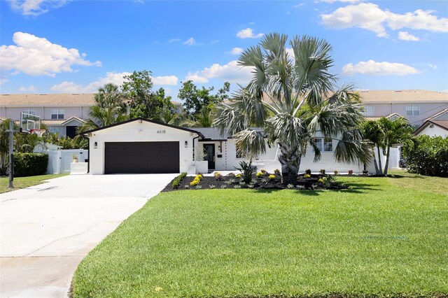 4618 Bayshore Blvd NE, Saint Petersburg, FL 33703 - view of front of home with a garage and concrete driveway