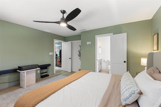 4618 Bayshore Blvd NE, Saint Petersburg, FL 33703 - bedroom with wood finished floors, connected bathroom, a ceiling fan, and baseboards