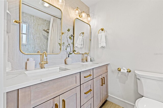 4618 Bayshore Blvd NE, Saint Petersburg, FL 33703 - bathroom with toilet, double vanity, baseboards, and curtained shower