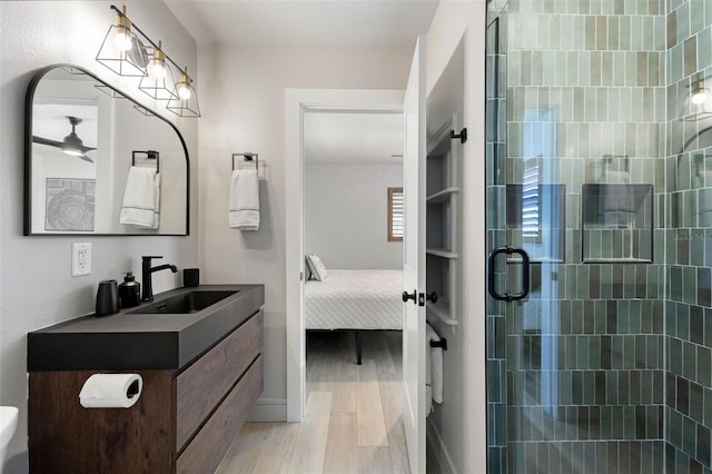 4618 Bayshore Blvd NE, Saint Petersburg, FL 33703 - ensuite bathroom featuring wood finished floors, a shower stall, and vanity