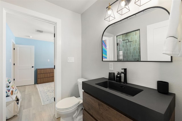 4618 Bayshore Blvd NE, Saint Petersburg, FL 33703 - full bathroom featuring toilet, wood finished floors, vanity, and tiled shower