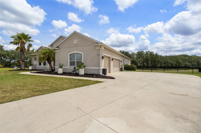 view of front facade with concrete driveway, an attached garage, and stucco siding