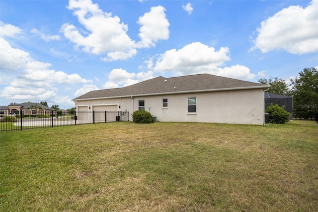 back of house with an attached garage, stucco siding, and driveway
