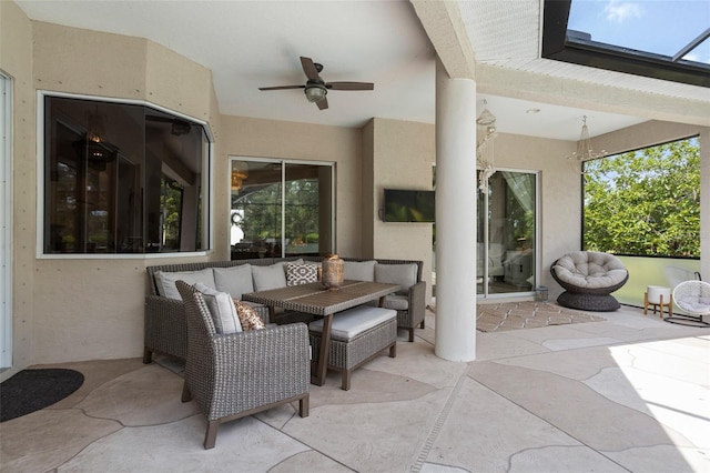 view of patio with a ceiling fan and an outdoor living space