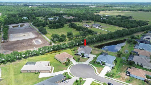 aerial view of property's location with a nearby body of water and nearby suburban area