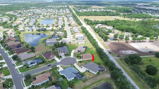 aerial view of property and surrounding area with nearby suburban area and a nearby body of water