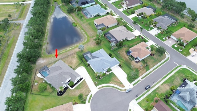 view of property location featuring a nearby body of water and nearby suburban area
