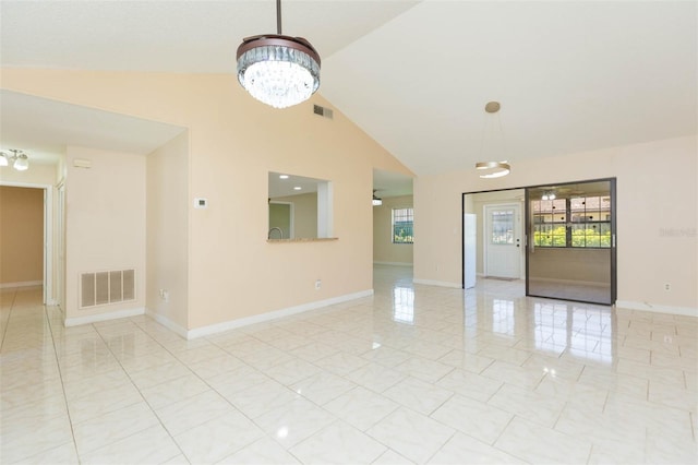 2211 Bay Berry Ln, Clearwater, FL 33763 - spare room with healthy amount of natural light, a chandelier, baseboards, and high vaulted ceiling