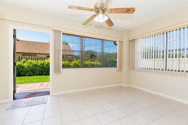 2211 Bay Berry Ln, Clearwater, FL 33763 - empty room with plenty of natural light, baseboards, and tile patterned floors