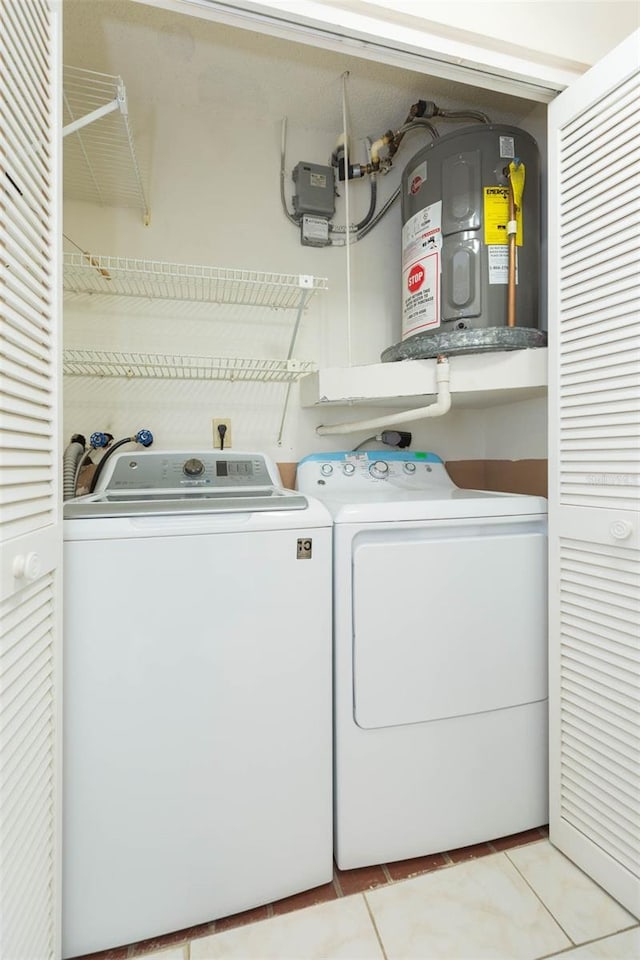 2211 Bay Berry Ln, Clearwater, FL 33763 - laundry area with washer and dryer, water heater, and light tile patterned flooring