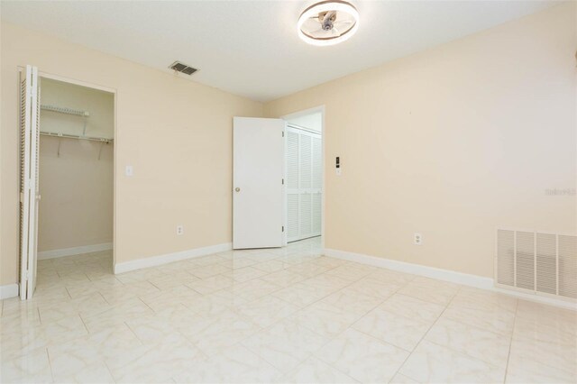 2211 Bay Berry Ln, Clearwater, FL 33763 - unfurnished bedroom with a walk in closet and baseboards
