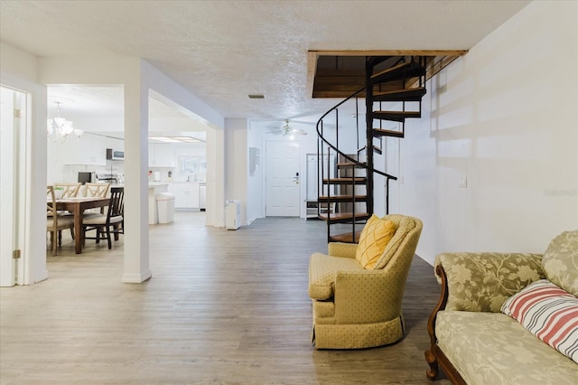 1010 Oakhill St, Seffner, FL 33584 - living room with wood finished floors, stairs, a chandelier, and a textured ceiling