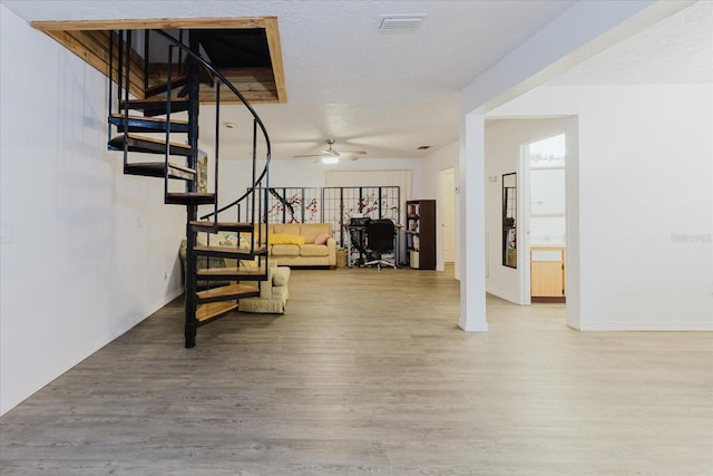1010 Oakhill St, Seffner, FL 33584 - stairs with wood finished floors, a ceiling fan, and baseboards