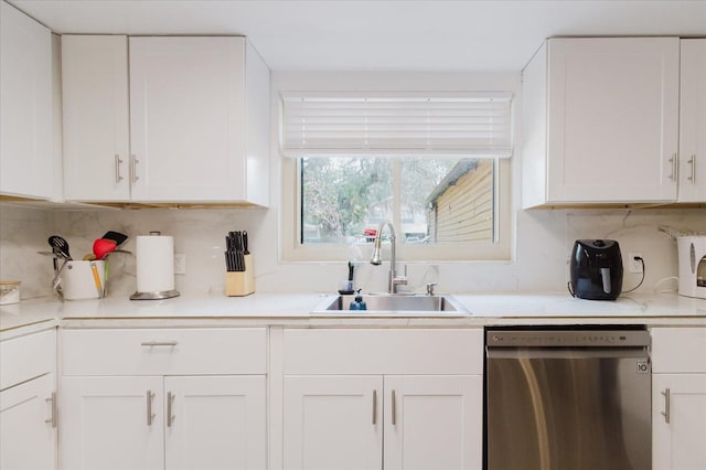 1010 Oakhill St, Seffner, FL 33584 - kitchen with dishwasher, a sink, white cabinets, and light countertops