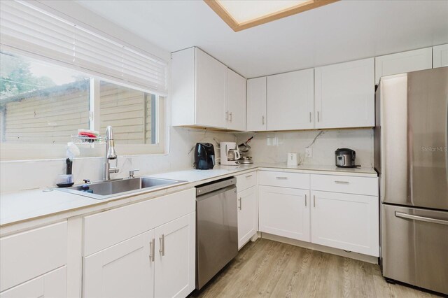 1010 Oakhill St, Seffner, FL 33584 - kitchen with appliances with stainless steel finishes, a sink, white cabinets, light wood-type flooring, and light countertops