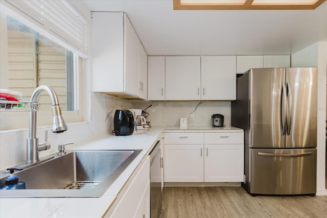 1010 Oakhill St, Seffner, FL 33584 - kitchen featuring appliances with stainless steel finishes, a sink, and white cabinetry