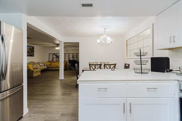 1010 Oakhill St, Seffner, FL 33584 - kitchen featuring freestanding refrigerator, ceiling fan, a peninsula, light wood-style floors, and white cabinetry