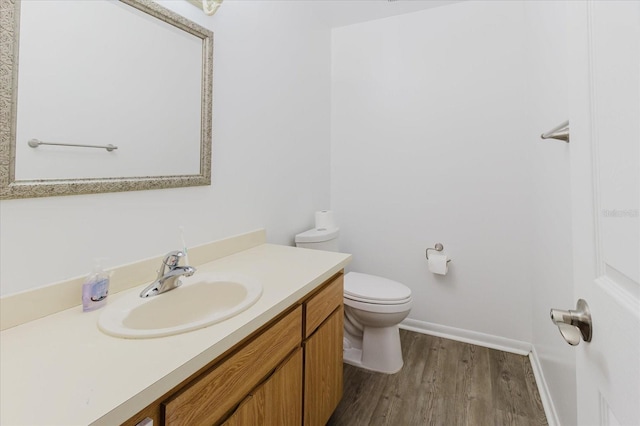 1010 Oakhill St, Seffner, FL 33584 - bathroom with wood finished floors, toilet, vanity, and baseboards