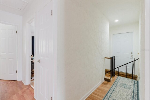 1010 Oakhill St, Seffner, FL 33584 - corridor with an upstairs landing, light wood finished floors, baseboards, and recessed lighting