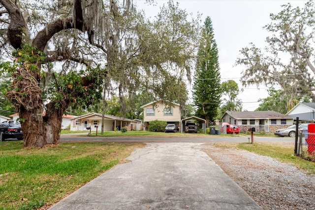1010 Oakhill St, Seffner, FL 33584 - view of front of home featuring a detached carport, asphalt driveway, and a residential view
