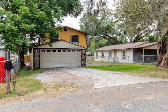 1010 Oakhill St, Seffner, FL 33584 - view of front facade with a garage, stone siding, and driveway