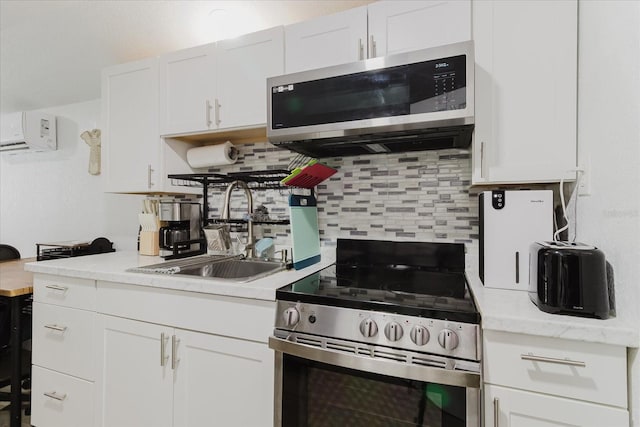 1010 Oakhill St, Seffner, FL 33584 - kitchen featuring appliances with stainless steel finishes, a sink, light countertops, tasteful backsplash, and white cabinets