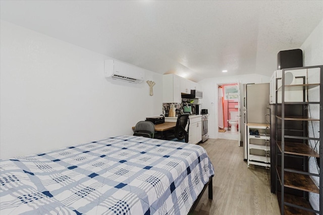 1010 Oakhill St, Seffner, FL 33584 - bedroom featuring an AC wall unit, light wood-style floors, and lofted ceiling